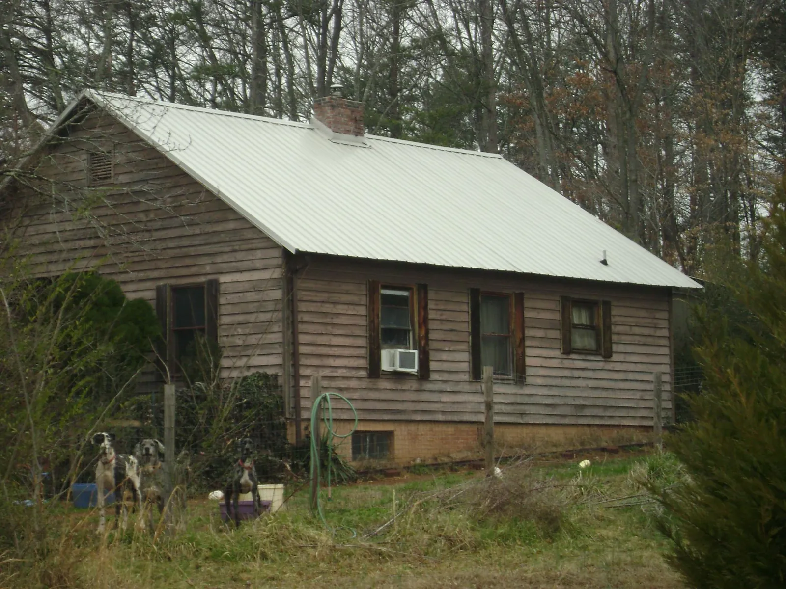 White metal roof on an old wood sided farmhouse, from a Metal Roof Installation job in Holyoke